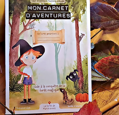 Illustration à l’aquarelle de la couverture du livret-jeu sur la forêt de Marchiennes, avec Jade la petite fille rousse, Pascal le triton doré et Fréquette le chien noir